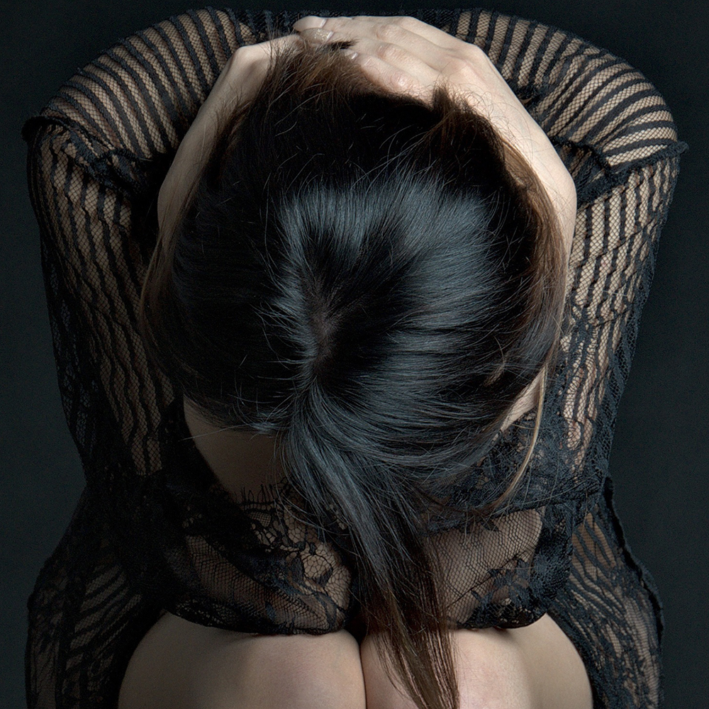 An artistic image representing the concern of hair loss (alopecia), a condition treated by the specialist physicians at Medinova in Kuala Lumpur.